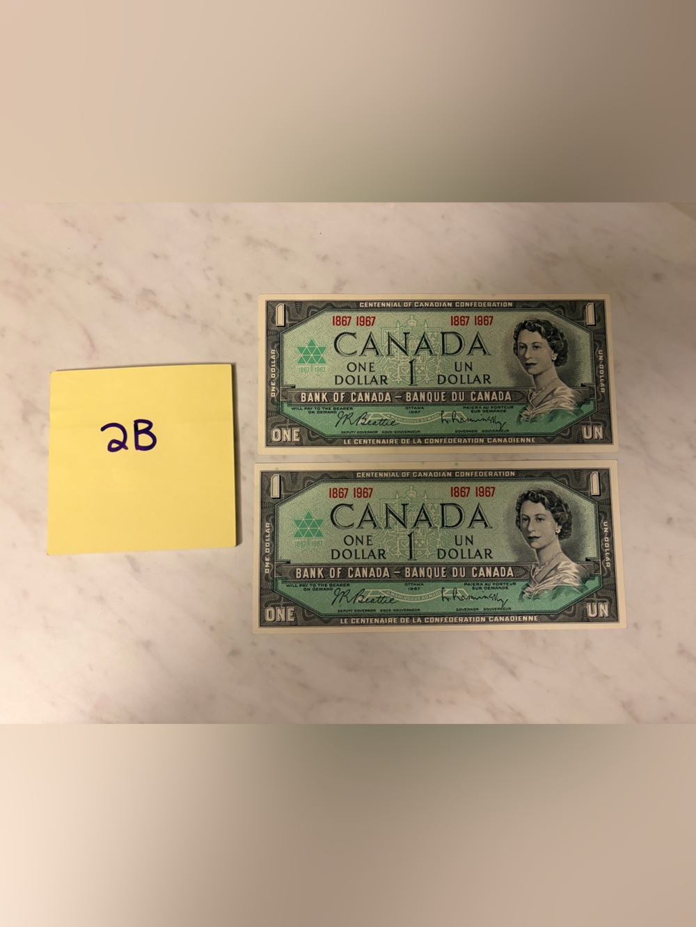 1967 set of 2 - Canada Centennial One Dollar Bills - Green - uncirculated